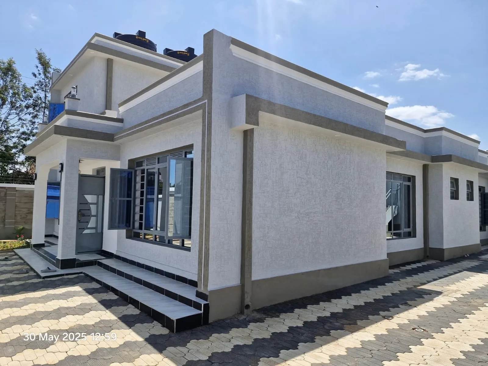 Completed modern residential building with a paved compound